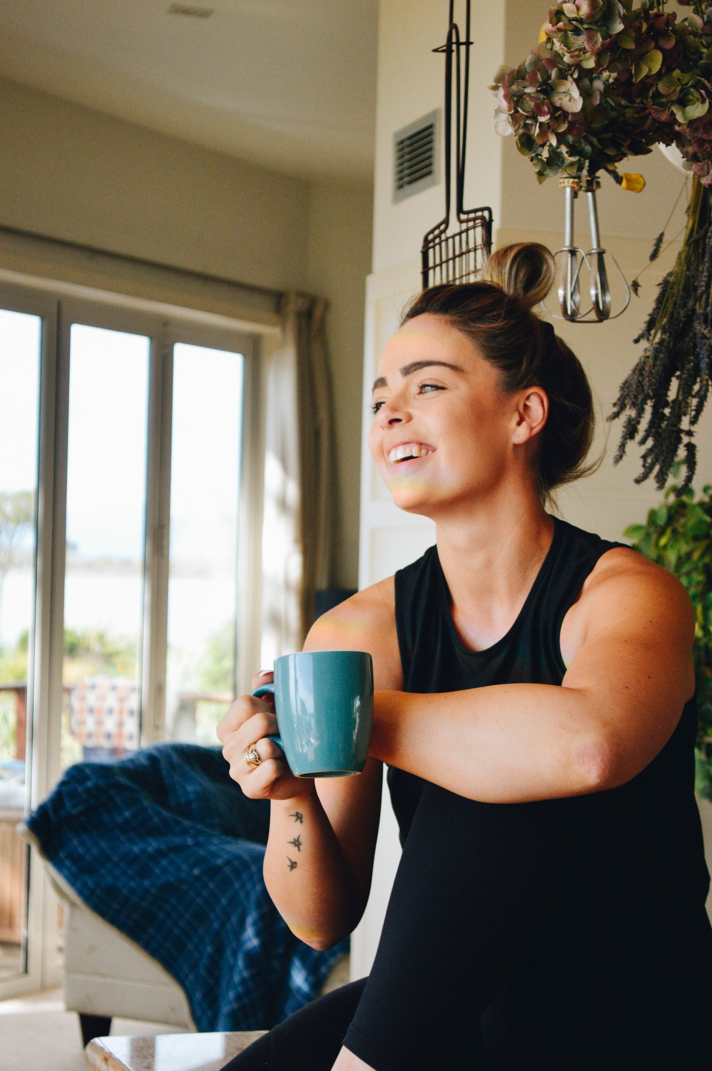 Steph Pearce, women's health and weight loss coach, sitting by a window